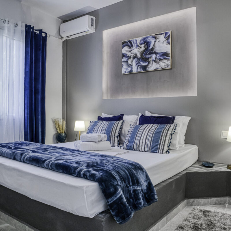Contemporary Comfort in Margio Bay Stylish Bedroom with Air Conditioning and Blue Accents