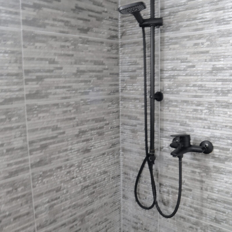 Contemporary Shower Design in greek thassos apartment Stylish Black Fixtures and Elegant Tiles details