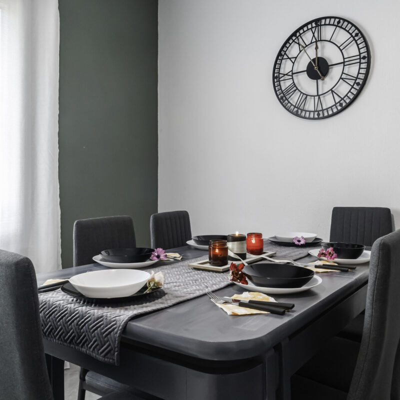 Modern Eating Area in Margio Bay Black Dishware, Fruit Bowl, and Comfortable Atmosphere