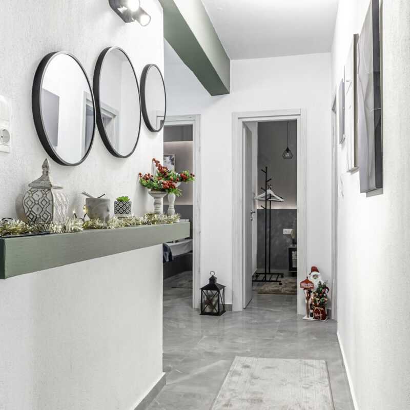 christmas Inviting Foyer at Margio Bay Stylish Mirrors, Decorative Lanterns, and Cozy Touches