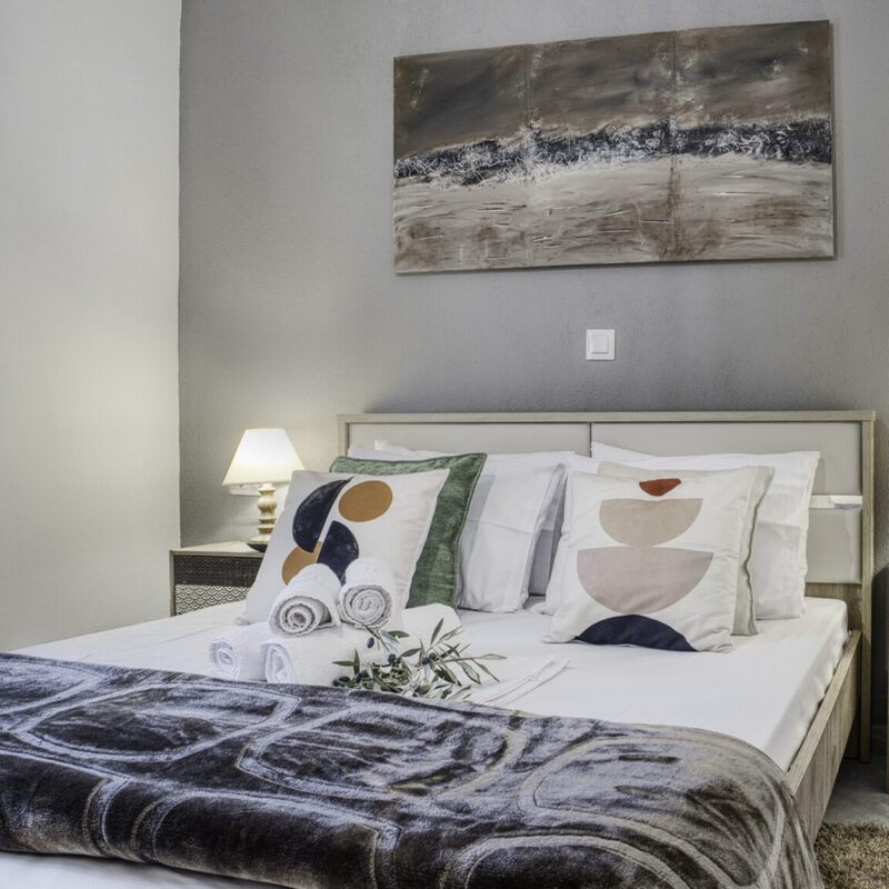 soft brown Charming Bedroom Retreat at Margio Bay Artistic Decor, Cozy Bed, and Lamps